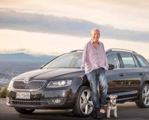 Steve Roome standing in front of Skoda vehicle with dog