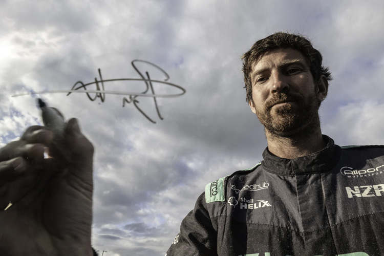 Ben Hunt giving his signature at a car rally